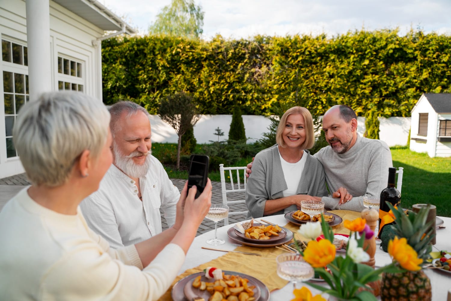 A joyful gathering of three seniors raising their wine glasses in a toast, surrounded by a festive atmosphere.
