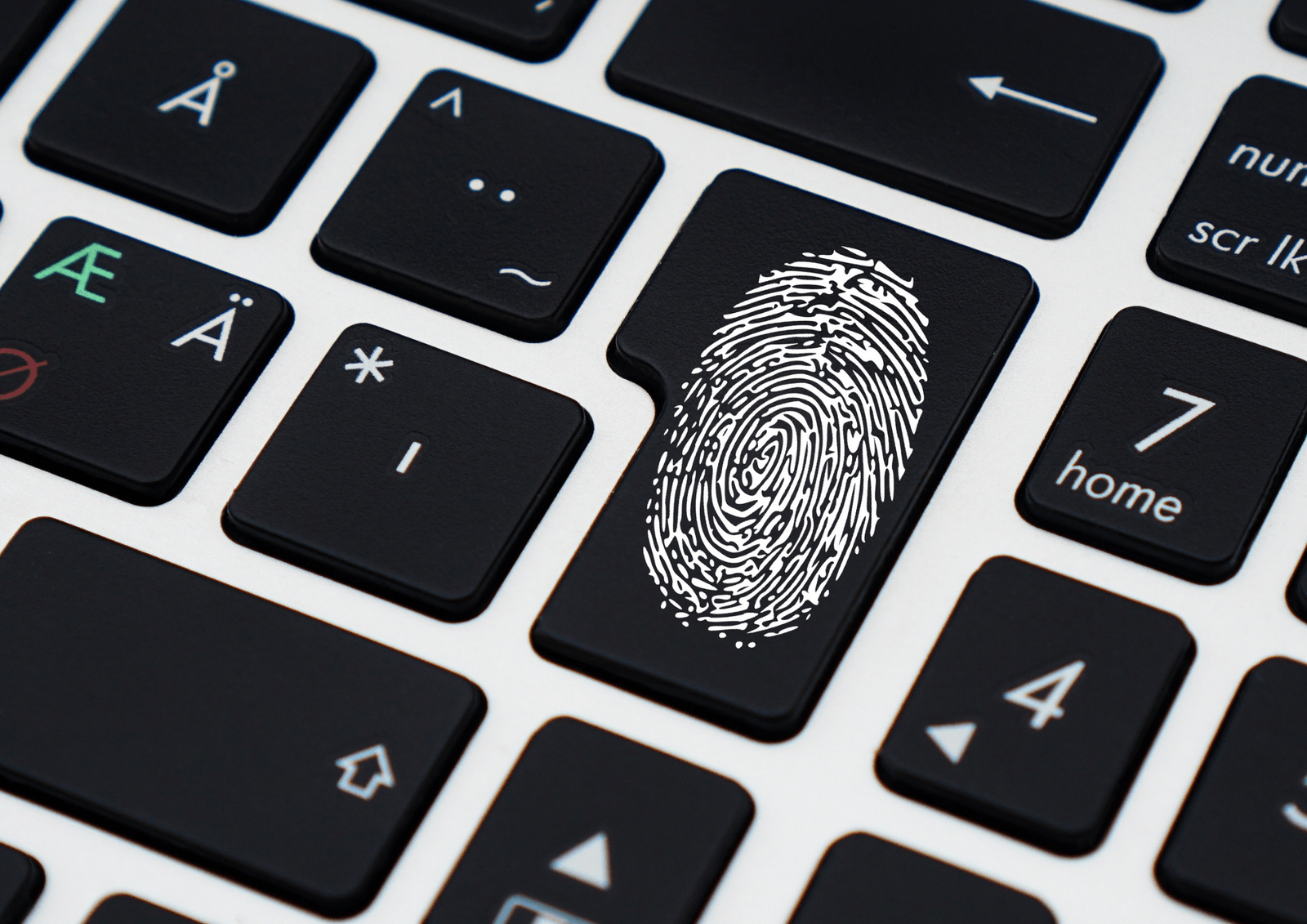 Close-up of a laptop keyboard with a fingerprint symbol printed on the enter key.