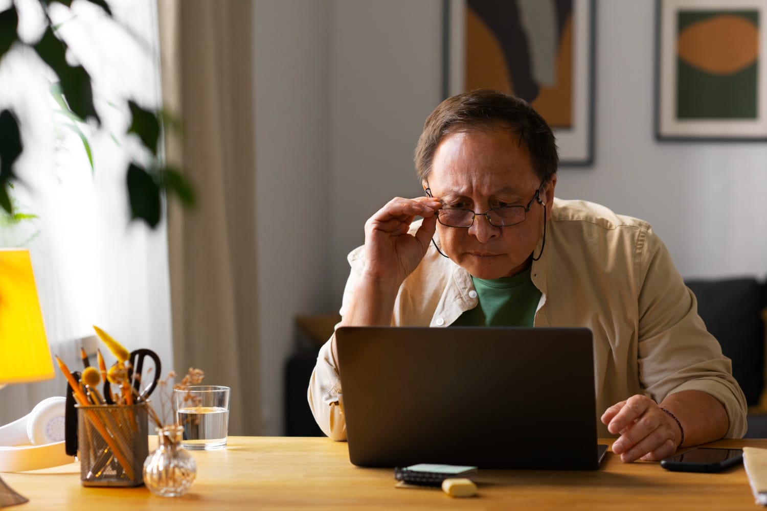 Portrait of older man using laptop at home