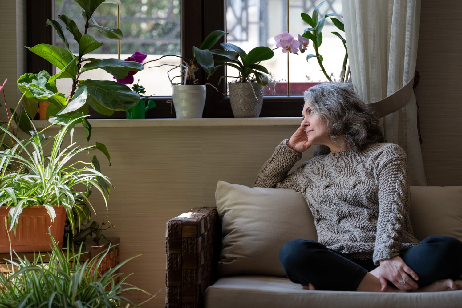 Sad elder woman on the sofa