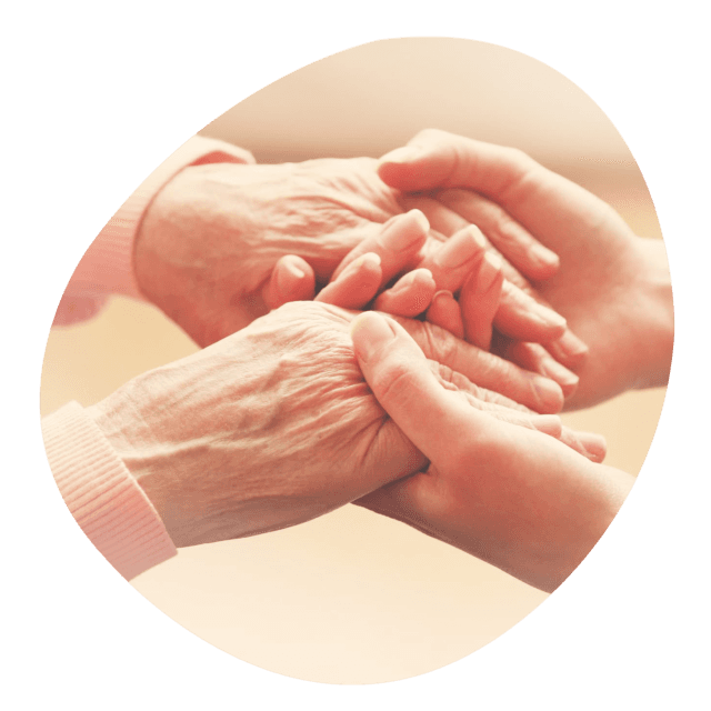 Hands of caregiver and resident clasped together